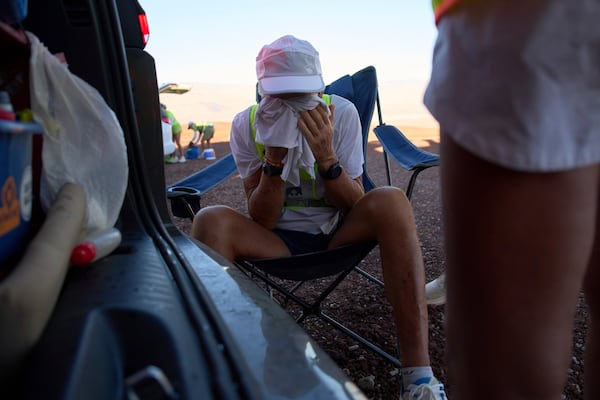 Danny Westergaard cools off in the shade while taking a short break during the Badwater 135 Ultramarathon, Tuesday, July 8, 2025, in Death Valley National Park, Calif. (AP Photo/John Locher)