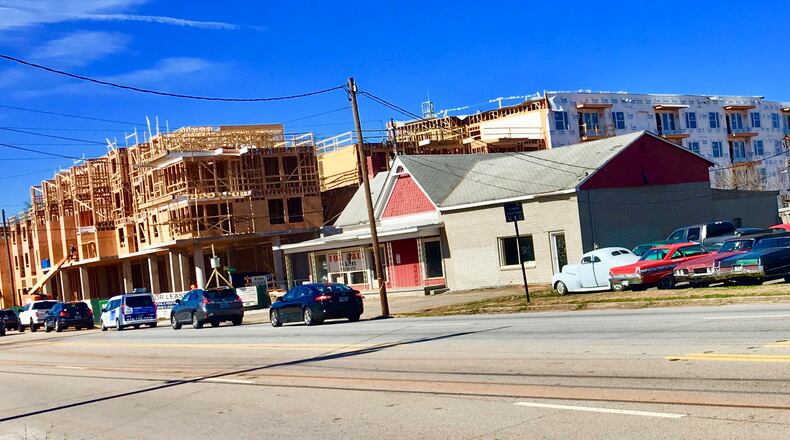 The foreground (with parked cars and abandoned building) is part of the site for a proposed 281-apartment development. Whether that project gets completed, or even started, likely depends on an August 27 Avondale Estates city commission vote. This week the city’s Architectural Review Board and Planning & Zoning Board declined recommending the development. Bill Banks file photo for the AJC