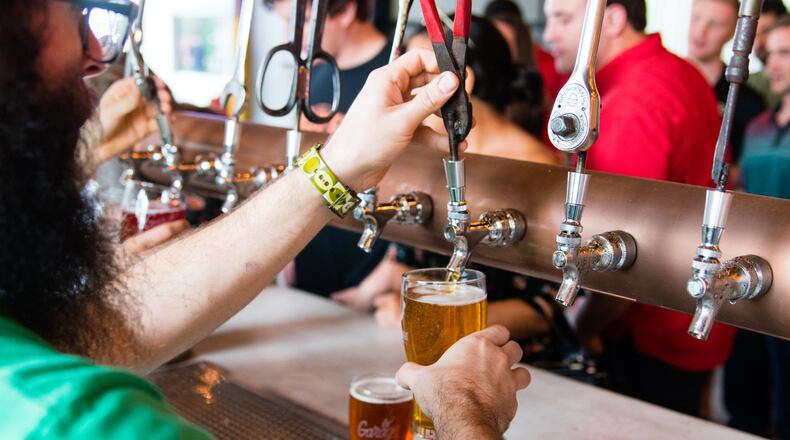 At the Garage (Monday Night Brewing’s second location), the large central bar has two sets of taps, allowing quick service for guests at the taproom. CONTRIBUTED BY HENRI HOLLIS