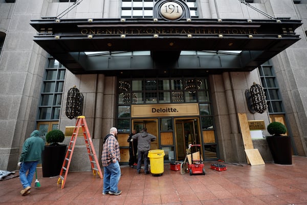 Cleaning personnel remove debris from broken doors and windows at 191 Peachtree Tower in downtown Atlanta on Sunday, January 22, 2023. The damage came in the wake of violent protests the night before against a proposed police training center. (Photo: Miguel Martinez / miguel.martinezjimenez@ajc.com)