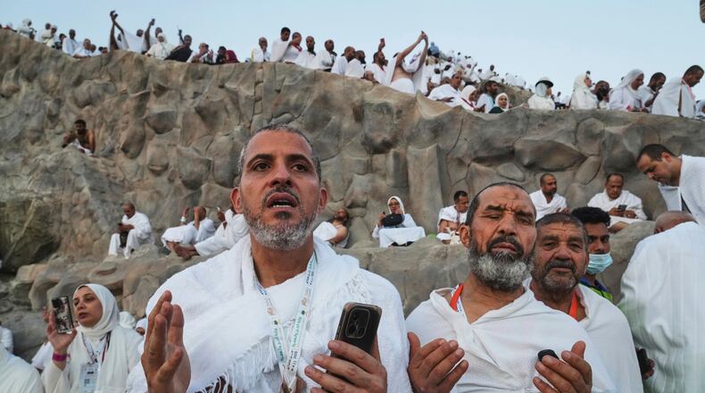 FILE - Muslim pilgrims offer prayers on the Mountain of Mercy, on the Plain of Arafat, during the annual Hajj pilgrimage near the holy city of Mecca, Saudi Arabia, June 5, 2025. (AP Photo/Amr Nabil, File)