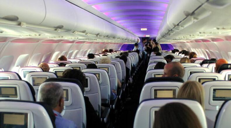 LOS ANGELES, CA - AUGUST 08:  Passengers in custom-designed leather chairs enjoy Virgin America airlines mood-lit cabins and in-flight entertainment system which includes on-demand movies, television, video games, music and onboard chat rooms during the first flights of Virgin America from Los Angeles and New York to its base of operations in San Francisco, California, Wednesday, August 8, 2007.   (Photo by Bob Riha/WireImage)