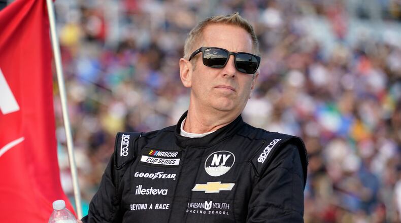 FILE - Greg Biffle looks on during driver introductions before the NASCAR Daytona 500 auto race at Daytona International Speedway, in Daytona Beach, Fla., Feb. 20, 2022. (AP Photo/John Raoux, File)