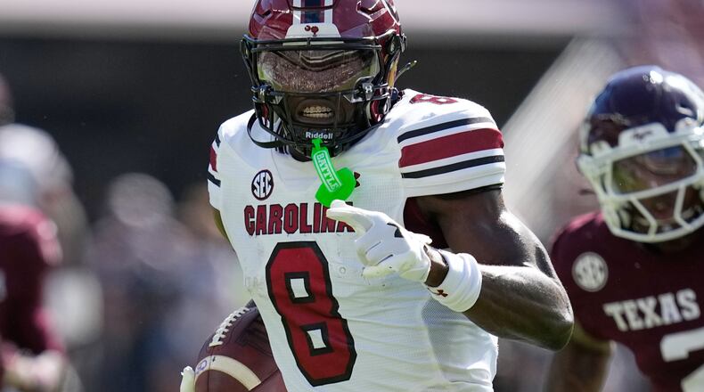 South Carolina wide receiver Nyck Harbor (8) runs for a touchdown after catching a pass as Texas A&M cornerback Dezz Ricks (2) defends during the first half of an NCAA college football game Saturday, Nov. 15, 2025, in College Station, Texas. (AP Photo/David J. Phillip)