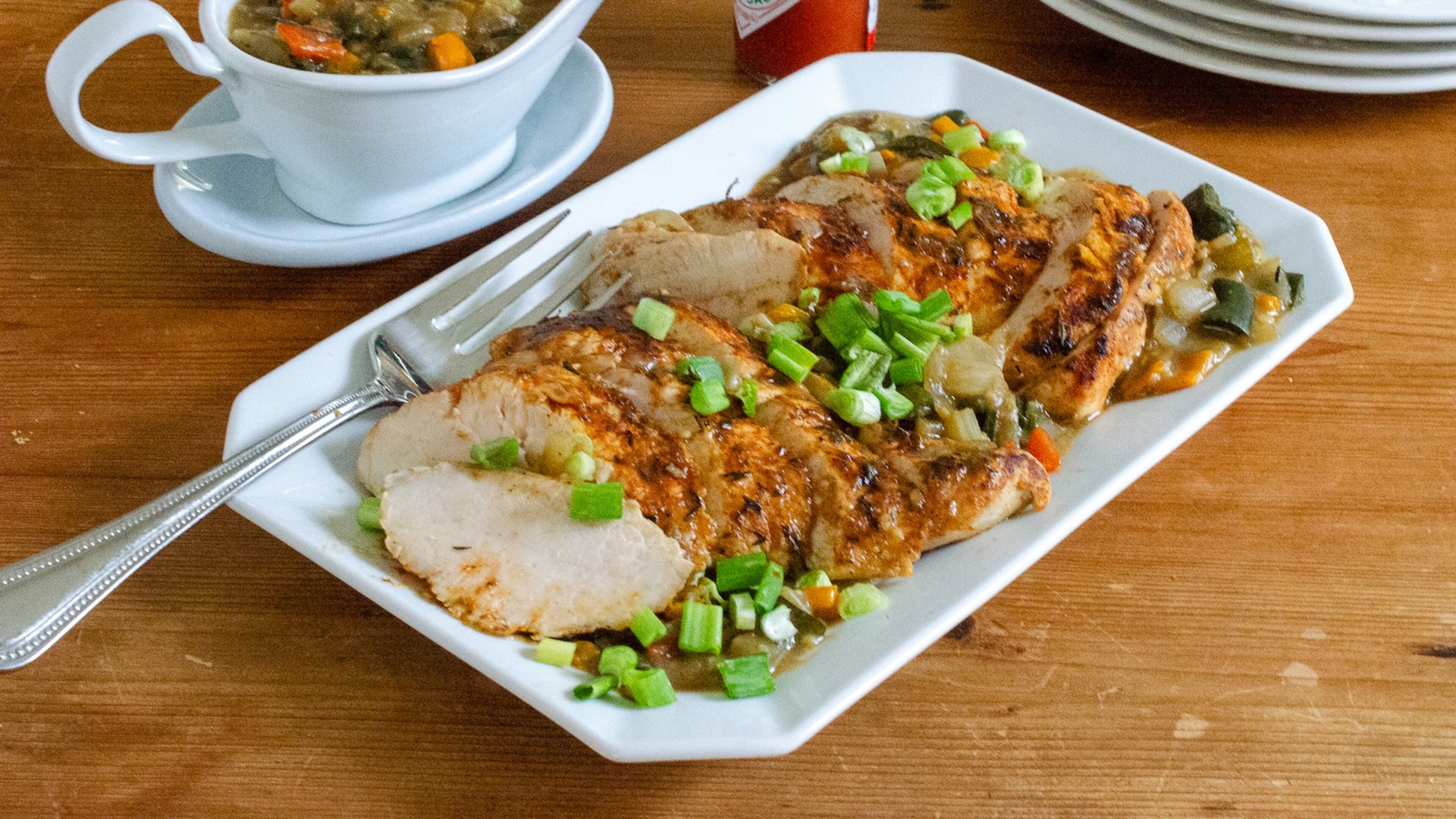 Turkey tenderloin with vegetable-packed spiced Creole gravy is rich in fiber and flavor and low in fat and calories. (Virginia Willis for the AJC)