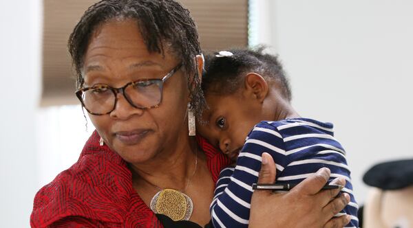 Wanda Irving holds Soleil Irving, 2, in their home in Sandy Springs, Georgia on Friday, April 19, 2019. Wanda Irving is raising her granddaughter, Soleil.  Her daughter, Dr. Shalon Irving, died in 2017 shortly after giving birth. Wanda Irving's daughter, Shalon, 36, died of cardiac arrest from complications related to hypertension three weeks after giving birth. (Emily Haney/AJC) 