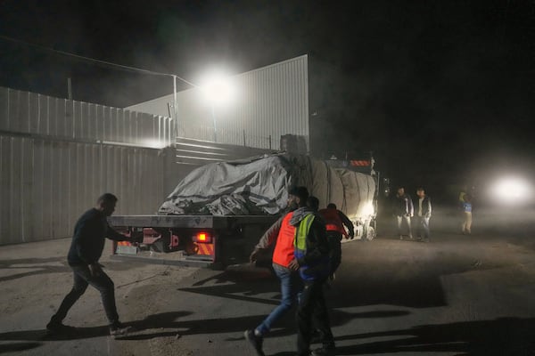 Aid trucks carrying food arrive at a World Food Program warehouse in Zawaida, central Gaza Strip, Wednesday, May 21, 2025. (AP Photo/Abdel Kareem Hana)