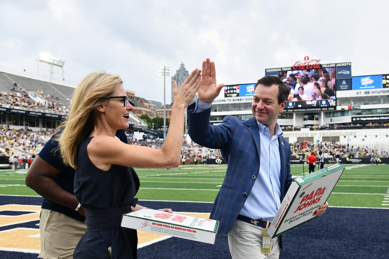 Athletic director Ryan Alpert (right) high-fives Karie Davis-Nozemack, interim provost and executive vice president for academic affairs, during Georgia Tech's game against Gardner-Webb in September at Bobby Dodd Stadium in Atlanta. (Hyosub Shin/AJC 2025)