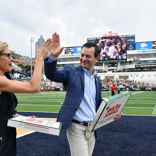 Athletic director Ryan Alpert (right) high-fives Karie Davis-Nozemack, interim provost and executive vice president for academic affairs, during Georgia Tech's game against Gardner-Webb in September at Bobby Dodd Stadium in Atlanta. (Hyosub Shin/AJC 2025)