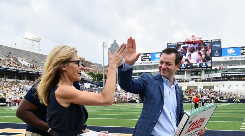 Athletic director Ryan Alpert (right) high-fives Karie Davis-Nozemack, interim provost and executive vice president for academic affairs, during Georgia Tech's game against Gardner-Webb in September at Bobby Dodd Stadium in Atlanta. (Hyosub Shin/AJC 2025)