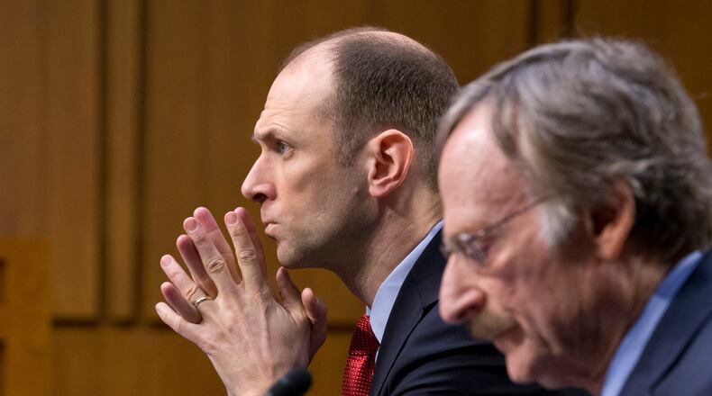 FILE - Austan Goolsbee, left, then-Council of Economic Advisers Chairman under President Barack Obama, testifies on Capitol Hill in Washingto, Feb. 28, 2013. (AP Photo/J. Scott Applewhite, File)