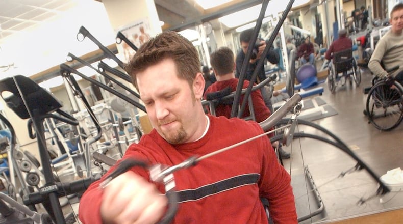 Terry Kirby works out at Shepherd Spinal Center in 2004. He was paralyzed when he was shot during a robbery at Sidelines Sports Grille about two years earlier. (SUNNY SUNG/AJC staff)