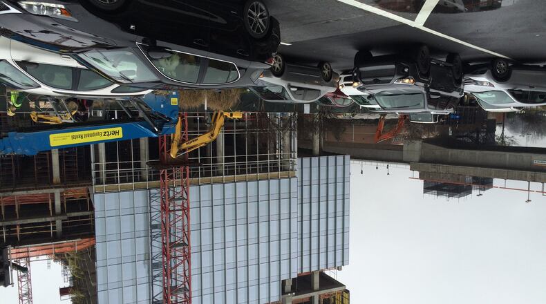 Workers build the first of up to four skyscrapers planned by State Farm near Perimeter Mall and the Dunwoody MARTA station. State Farm has been a driver of activity around the Perimeter Mall area, and another developer is planning a mix of office and residential towers nearby.