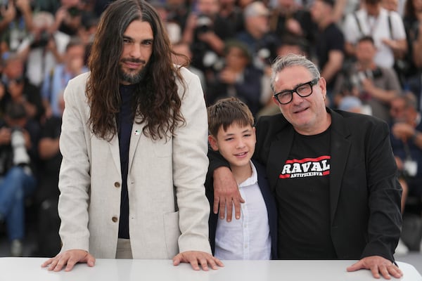 Director Oliver Laxe, from left, Bruno Nunez, and Sergi Lopez pose for photographers at the photo call for the film 'Sirat' at the 78th international film festival, Cannes, southern France, Friday, May 16, 2025. (Photo by Lewis Joly/Invision/AP)