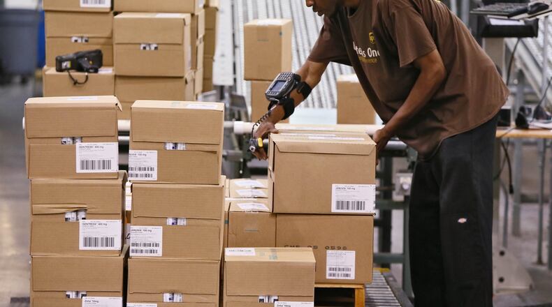 September 19, 2014 - Suwanee - Using a wrist mounted bar code reader, Kyle Kelly readies a shipment from the healthcare distribution center in Suwanee. UPS does logistics for healthcare companies at its facility in Suwanee, and other companies including Pratt & Whitney at its distribution center near Hartsfield Jackson Airport. Logistics is the engine humming behind much of Atlanta’s economic activity connected to the rest of the world. It’s the backbone for a globalized economy, and Sandy Springs-based UPS, Atlanta-based Manhattan Associates and other local companies play leading roles in the industry. BOB ANDRES / BANDRES@AJC.COM