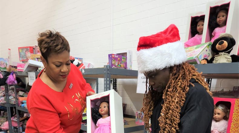 LaShanda Pitts (left), founder of 518 Social, and volunteer Felicia Jackson pack toys for the Salvation Army's Angel Tree project.
