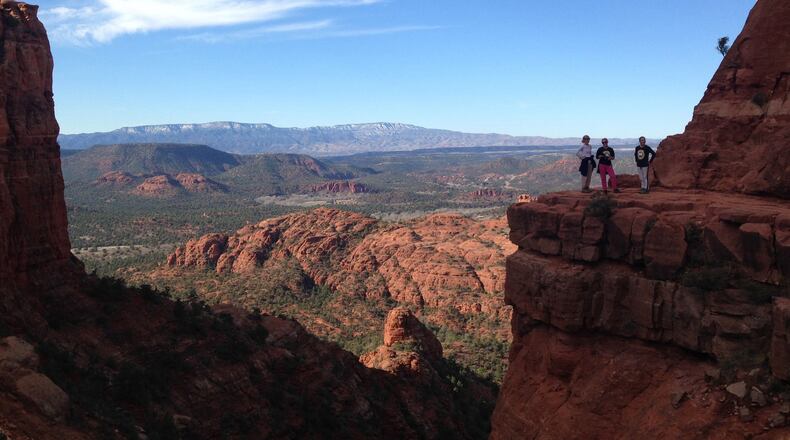 A family poses for a picture on a ledge near high up Cathederal Rock near Sedona, Arizona. (Craig Hill/The News Tribune/TNS)