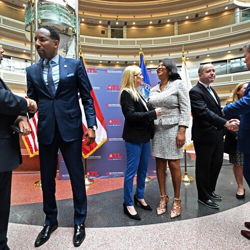 Atlanta Mayor Andre Dickens (second from left) and Governor Brian Kemp (right) greet guests after a human trafficking prevention press conference at Hartsfield-Jackson Atlanta International Airport on Jan. 31, 2023. (Hyosub Shin/AJC)