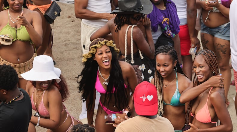 A crowd of partiers gather on the beach for Orange Crush in Tybee Island on Saturday, April 20, 2024. The island put various traffic and safety protocols in place in anticipation of large crowds in town Orange Crush, an annual spring break gathering for college students. (Natrice Miller/ AJC)