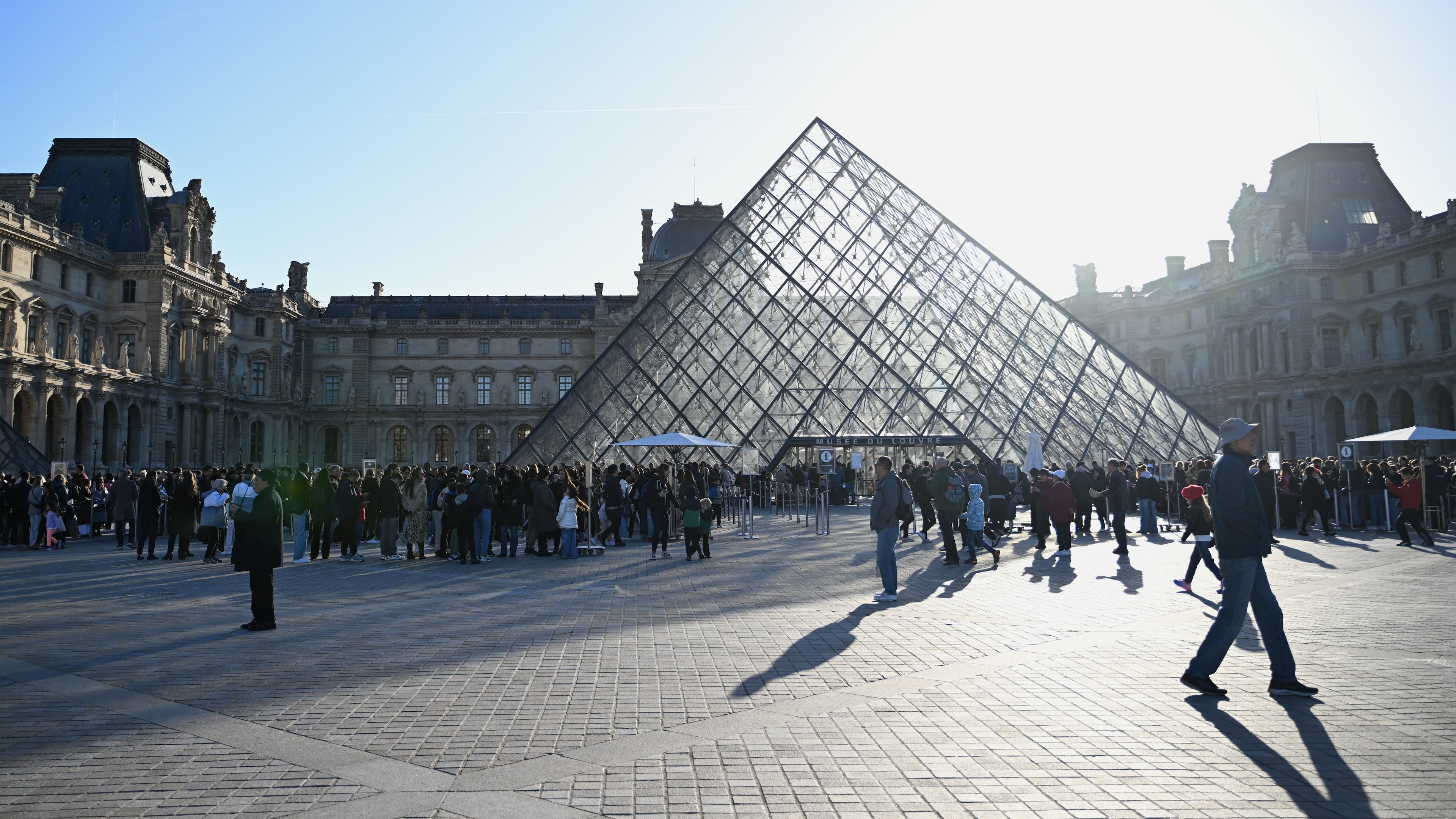 People queue to enter the Louvre museum, Thursday, Oct. 30, 2025 in Paris. (AP Photo/Emma Da Silva)