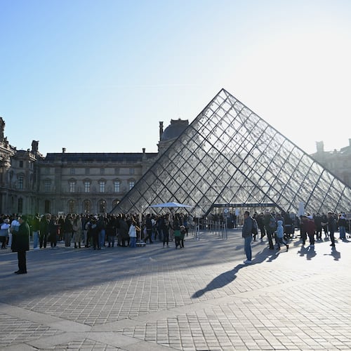 People queue to enter the Louvre museum, Thursday, Oct. 30, 2025 in Paris. (AP Photo/Emma Da Silva)