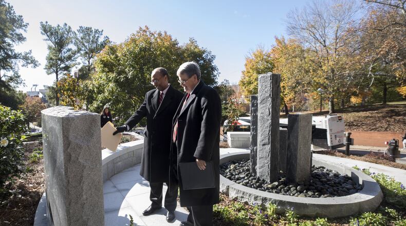 Judge Steve Jones, U.S. District Court Judge for the Northern District of Georgia, and UGA President Jere W. Morehead read the inscription at the Baldwin Hall Memorial. Credit: University of Georgia