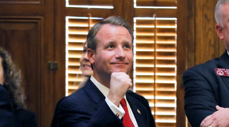 Mar. 9,  2017 - Atlanta - Sen. John Albers, R-Roswell, who is a volunteer firefighter, gives a fist pump to firefighters in the Senate gallery after the passage of House Bill 146, sponsored by state Rep. Micah Gravley, R-Douglasville, and backed by Speaker David Ralston, R-Blue Ridge.  The Georgia Senate unanimously backed a measure Thursday offering firefighters special insurance policies to cover treatment of certain work-related cancers, bringing it a crucial step closer toward final passage. The 30th legislative day of the 2017 Georgia General Assembly.   BOB ANDRES  /BANDRES@AJC.COM