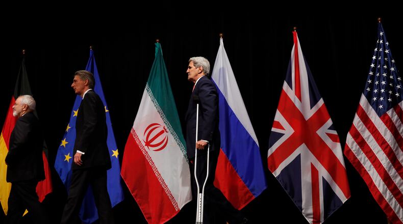 The perfect metaphor for our negotiating position: Iranian Foreign Minister Mohammad Javad Zarif leads British Foreign Secretary Philip Hammond and a hobbled John Kerry off the stage in Vienna Tuesday. (Carlos Barria / Pool Photo via AP)