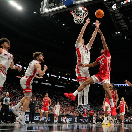 Houston's Mercy Miller (25) shoots over Arizona's Motiejus Krivas (13) during the first half of an NCAA college basketball game in the championship of the Big 12 Conference tournament Saturday, March 14, 2026, in Kansas City, Mo. (AP Photo/Charlie Riedel)