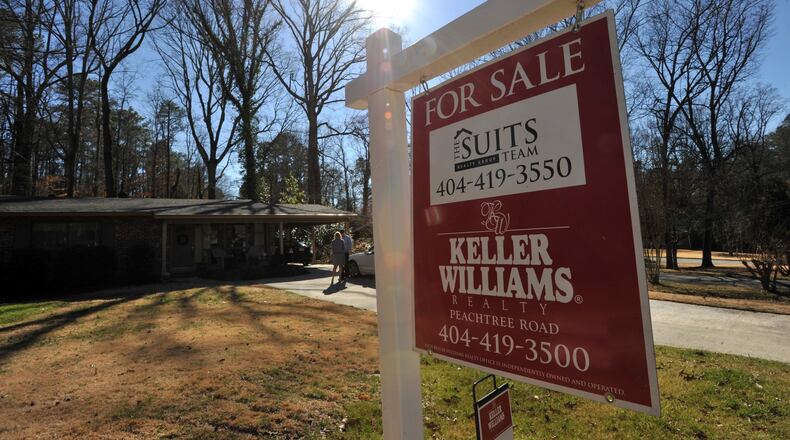 Real estate agent Collette McDonald and her intern Gunner DeLay wait for their client Dawn Ramsey outside a house for sale in Brookhaven on Friday, February 21, 2014. Fewer metro Atlanta houses were sold in January than the year before and the month before - the result of cold weather and supply that remains low. But the median price of purchased homes rose, another result of low inventory and an indication that fewer distressed houses are on the market. HYOSUB SHIN / HSHIN@AJC.COM