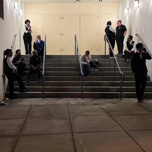 Attendees and hotel workers evacuate after an incident at the Washington Hilton during the White House Correspondents Dinner, Saturday, April 25, 2026, in Washington. (AP Photo/Mark Schiefelbein)