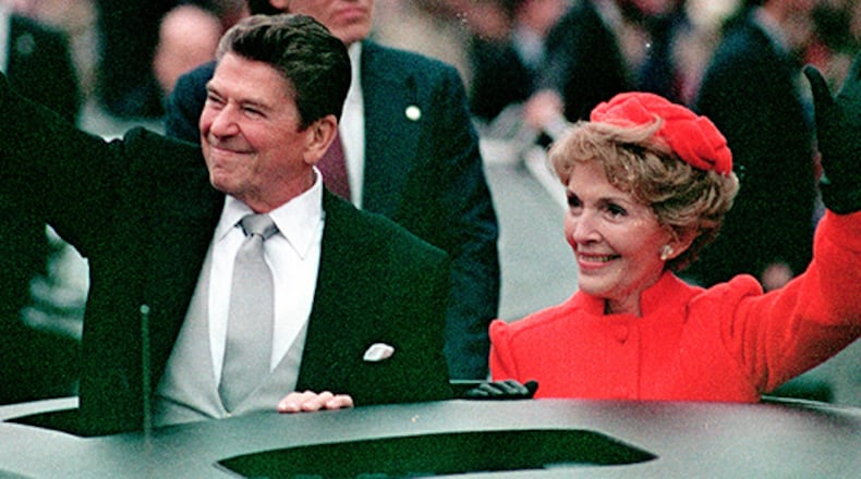 This Jan. 20, 1981 file photo, shows President Ronald Reagan as he gives a thumbs up to the crowd while his wife, first lady Nancy Reagan, waves from a limousine during the inaugural parade in Washington following Reagan's swearing in as the 40th president of the United States. Sunday, Feb. 6, 2011, marks the centennial anniversary of Reagan's birth.
