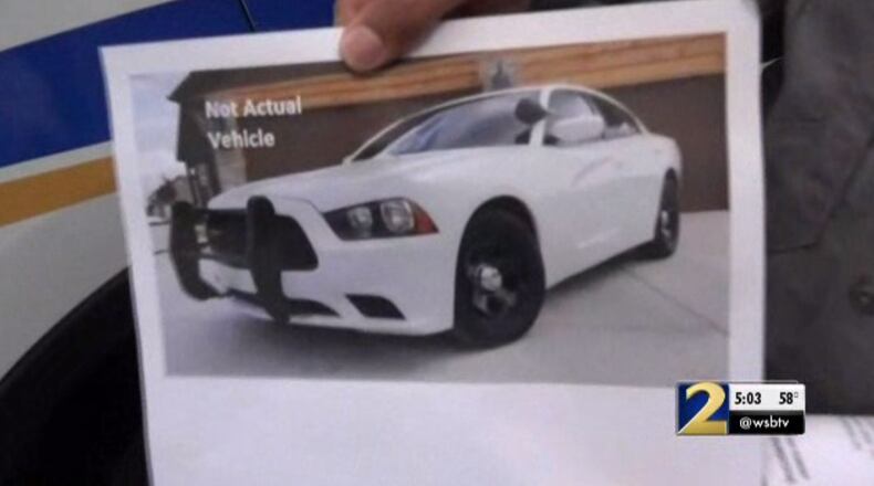 Authorities are searching for two men who posed as police officers, accused of robbing a couple at gunpoint during a "traffic stop."