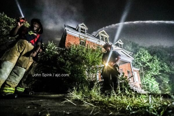 Atlanta firefighters continue to put out hot spots on the scene of a large fire near Morris Brown College on Thursday morning. Flames could be seen for miles as the fire raged Wednesday night. 