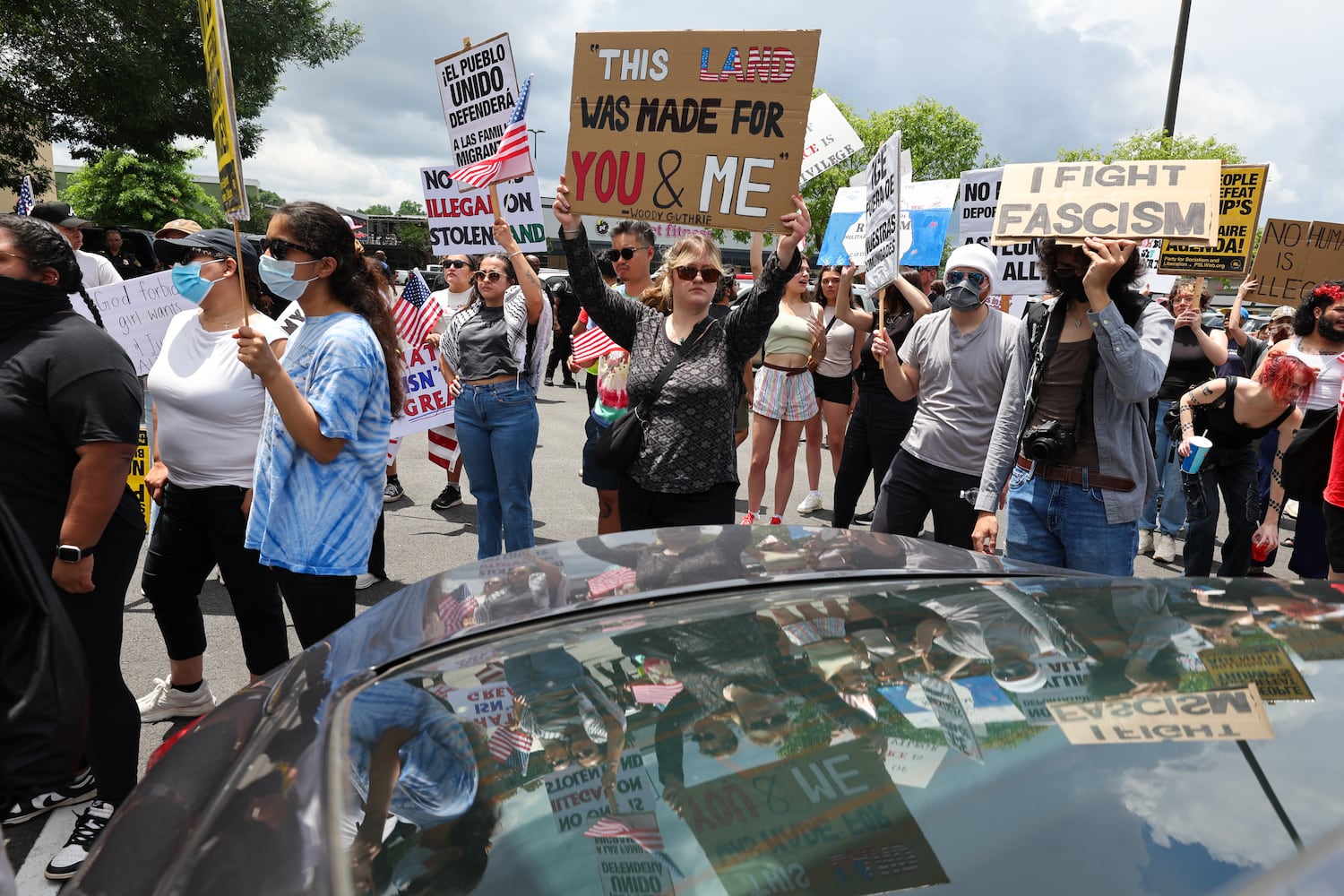 Demonstrators are seen during a protest on ICE raids and deportation arrests on Chamblee Tucker Road in Atlanta on Saturday, June 14, 2025. (Arvin Temkar / AJC)