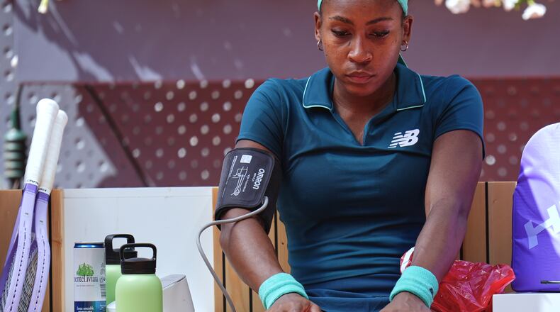 Coco Gauff of the United States receives medical attention during her match against Sorana Cirstea of Romania at the Madrid Open tennis tournament, Sunday, April 26, 2026, in Madrid. (AP Photo/Manu Fernandez)
