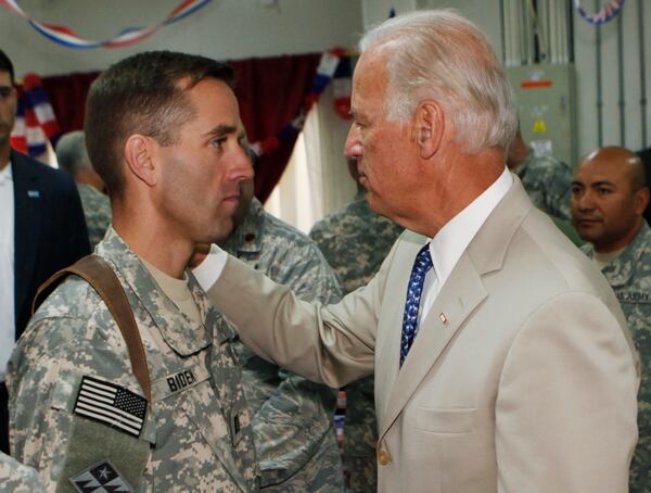 FILE - In this Saturday, July 4, 2009. file photo, U.S. Vice President Joe Biden, right, talks with his son, U.S. Army Capt. Beau Biden, at Camp Victory on the outskirts of Baghdad, Iraq. On Saturday, May 30, 2015, Vice President Biden announced the death of son, Beau, from brain cancer. (AP Photo/Khalid Mohammed, Pool)