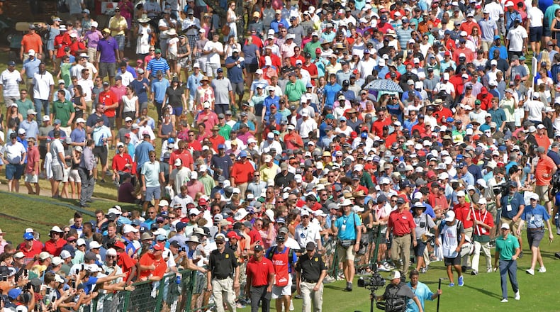 Tiger Woods tends to draw a crowd, as here on the ninth fairway at East Lake Sunday. (HYOSUB SHIN / HSHIN@AJC.COM)
