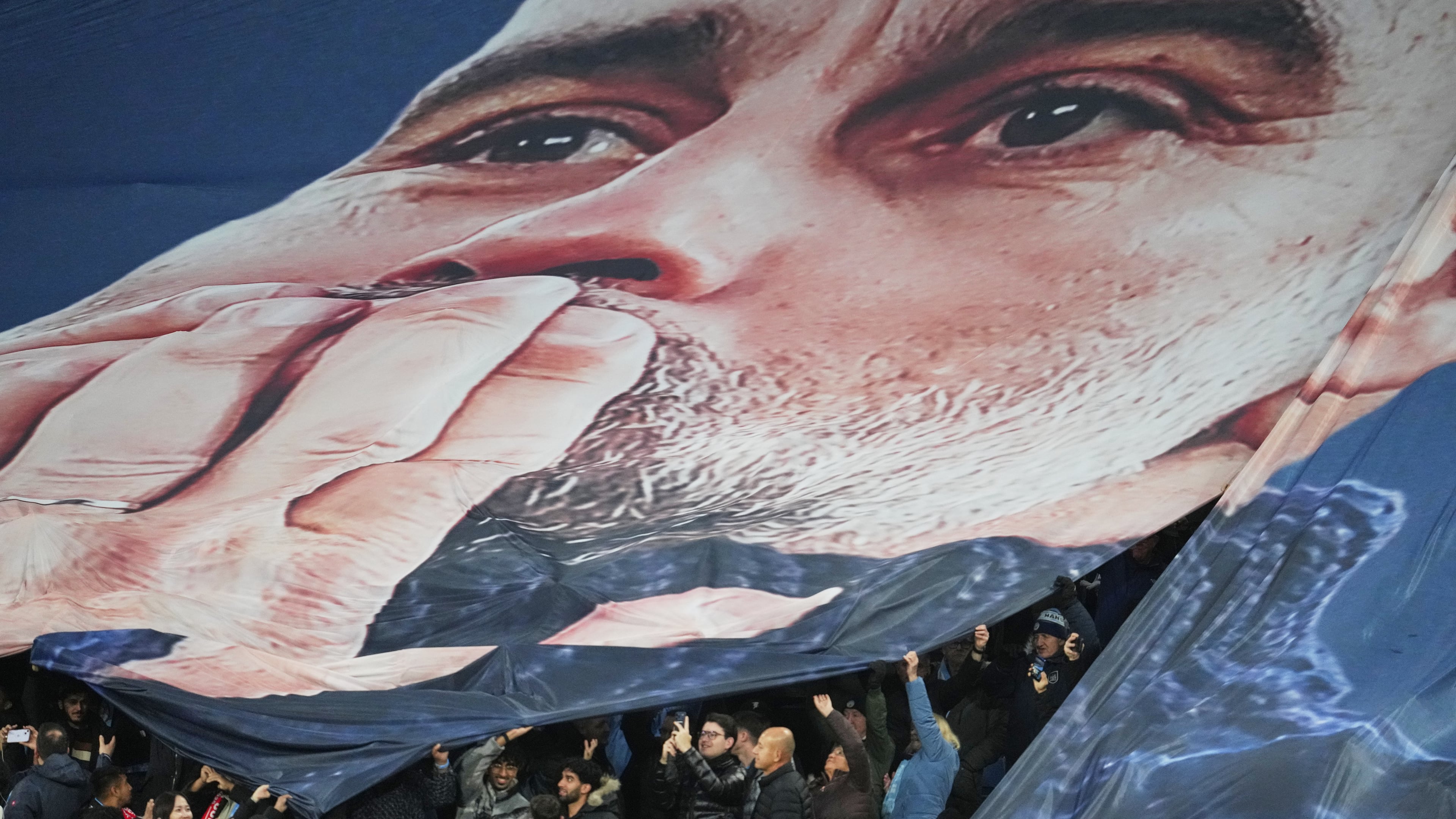 Fans tribute to Pep Guardiola coach of Manchester City 1000th game during the English Premier League soccer match between Manchester City and Liverpool in Manchester, England, Sunday, Nov. 9, 2025. (AP Photo/Jon Super)