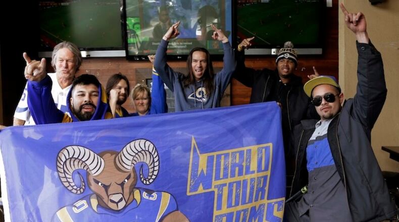 Rams fans celebrate the impending return of the NFL football team to Los Angeles, at Big Wangs sports bar in the North Hollywood area of Los Angeles on Wednesday, Jan. 13, 2016. League owners voted Tuesday to allow the St. Louis Rams to move to Los Angeles starting next season. (AP Photo/Nick Ut)