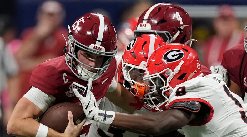 Alabama quarterback Ty Simpson (15) is tackles by Georgia linebacker Chris Cole (9) during the second half of a Southeastern Conference championship NCAA college football game, Saturday, Dec. 6, 2025, in Atlanta. (AP Photo/Mike Stewart)