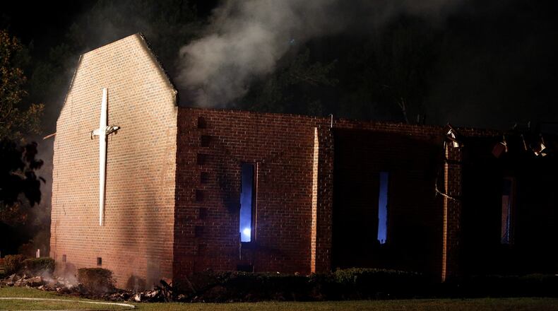 Smoke rises from Mount Zion African Methodist Episcopal church late Tuesday, June 30, 2015, in Greeleyville, S.C., which caught fire Tuesday. The African-American church that was burned down by the Ku Klux Klan in 1995 caught fire again Tuesday night. (Veasey Conway/The Morning News via AP)