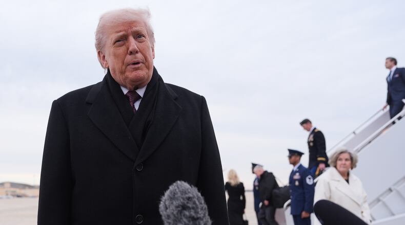 President Donald Trump talks to reporters after arriving on Air Force One, Wednesday, Dec. 17, 2025, at Joint Base Andrews, Md., after attending a casualty return at Dover Air Foce Base. (AP Photo/Evan Vucci)