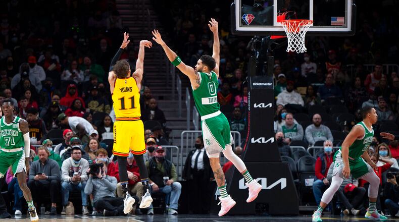 Atlanta Hawks guard Trae Young (11)shoots over Boston Celtics forward Jayson Tatum (0) during the first half of an NBA basketball game Friday, Jan. 28, 2022, in Atlanta. (AP Photo/Hakim Wright Sr.)