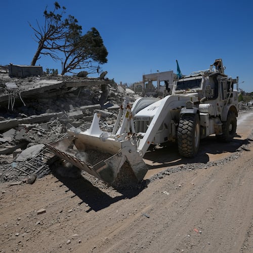 A bulldozer for the Spanish U.N peacekeeper opens a road in front of a house that was destroyed in the recent clashes between Hezbollah fighters and Israeli troops in Dibbine village, southeast Lebanon, Friday, June 5, 2026, a day after Israeli forces withdrew. (AP Photo/Hussein Malla)