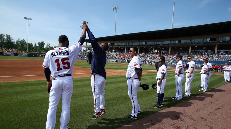6'5" tall Atlanta Braves outfielder Jason Heyward stands still as 5'9" tall Gwinnett Braves outfielder Jose Constanza jumps to high-five Heyward before their game.