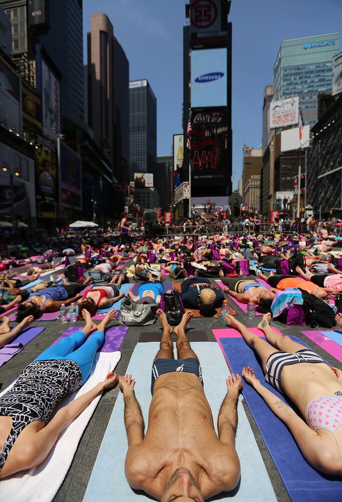 Enthusiasts perform yoga in Times Square to mark summer solstice, June 21, 2013