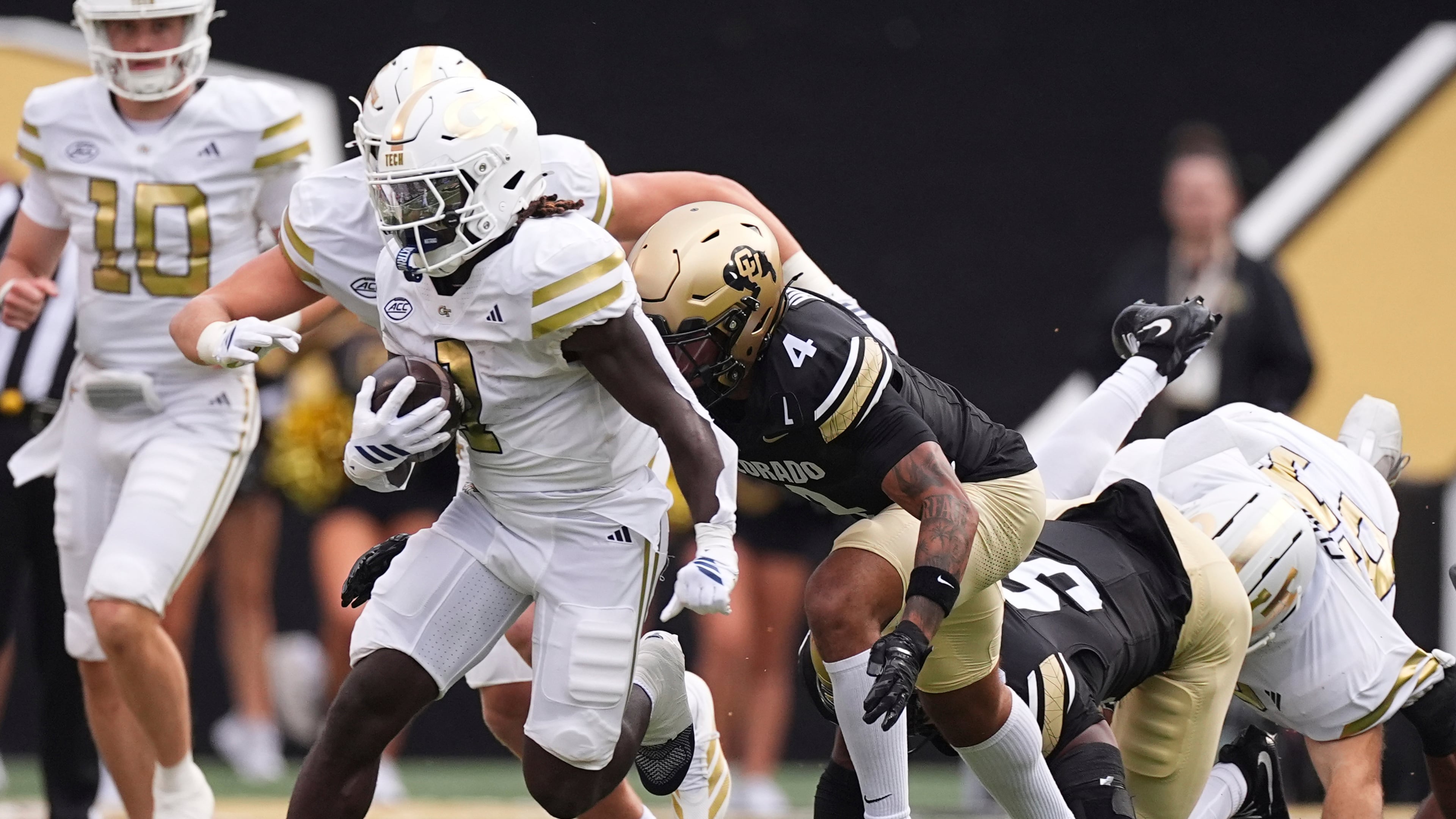 Georgia Tech running back Jamal Haynes, left, runs for a long gain past Colorado cornerback Preston Hodge, center, and linebacker Reginald Hughes in the first half of an NCAA college football game Friday, Aug. 29, 2025, in Boulder, Colo. (David Zalubowski/AP)