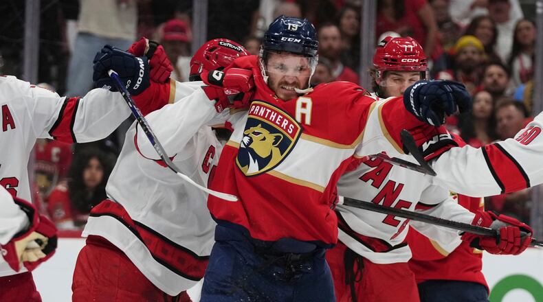 FILE - Florida Panthers left wing Matthew Tkachuk (19) scuffles with Carolina Hurricanes players during the second period in Game 3 of the NHL hockey Stanley Cup Eastern Conference finals Saturday, May 24, 2025, in Sunrise, Fla. (AP Photo/Lynne Sladky, File)