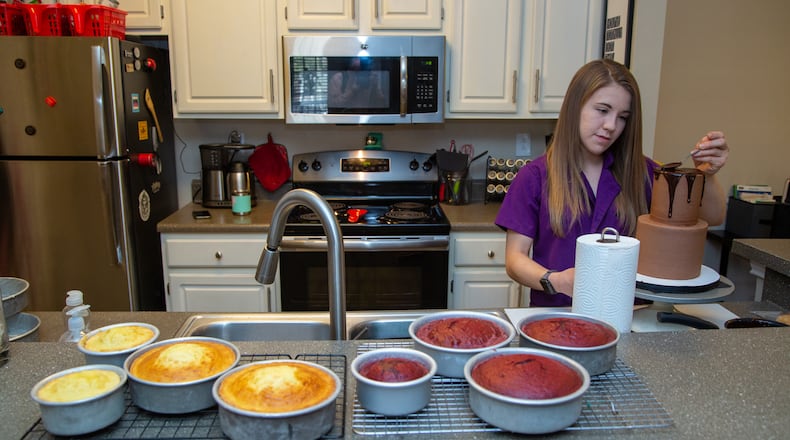Heaven Waits of Heavenly Bakes works in the kitchen of her Buford apartment.  PHIL SKINNER FOR THE ATLANTA JOURNAL-CONSTITUTION.